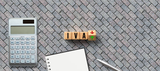 cubes with Spanish abbreviation for VAT and up and down arrows and a calculator stock photo