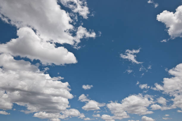 Cumulus Clouds in a Blue Sky Cumulus clouds appear in a blue sky over Kendrick Park in the Coconino National Forest near Flagstaff, Arizona, USA. jeff goulden cloud backgrounds stock pictures, royalty-free photos & images