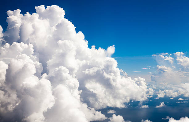 Cumulus clouds-eye level seen from an airplane stock photo