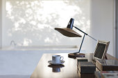 istock Cup of coffee and lamp on desk in office 184315871