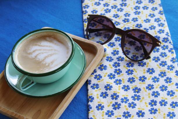 A cup of coffee  on  table cloth with  sunglasses,selective focus . stock photo