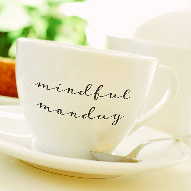 cup of coffee or tea with the text mindful monday stock photo