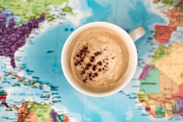 Cup of coffee with cinnamon Cup of coffee with cinnamon from above over world map background surface spices of the world stock pictures, royalty-free photos & images