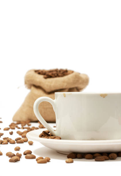 Cup of coffee with coffee beans around stock photo