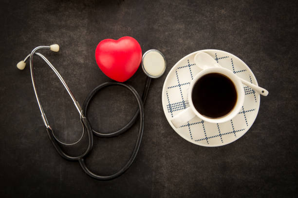 Cup of coffee with stethoscope and red heart. stock photo