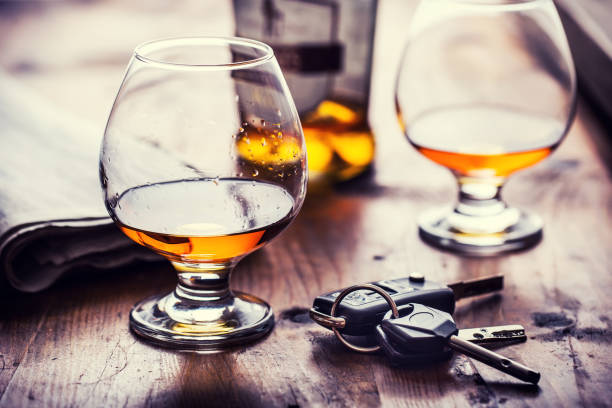 Cup of cognac whiskey or brandy and the keys car. stock photo