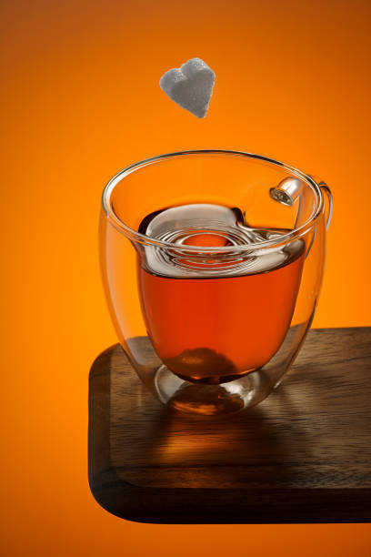 A cup of tea and a piece of sugar stock photo