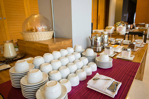Cups, plates and utensils arranged and buffet stock photo