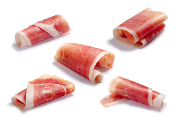 Cured meat ham jamon slice rolled up, paths Jamon, Prosciutto, Speck, Dry Cured Meat or Ham slice, rolled up. Clipping paths for each, shadows separated prosciutto stock pictures, royalty-free photos & images