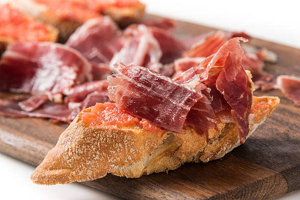Cured Serrano Ham Canapes Cured Serrano Ham Canapes on white tapas stock pictures, royalty-free photos & images