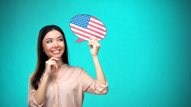 Curious woman holding USA flag sign, learning language, education abroad Curious woman holding USA flag sign, learning language, education abroad english language stock pictures, royalty-free photos & images
