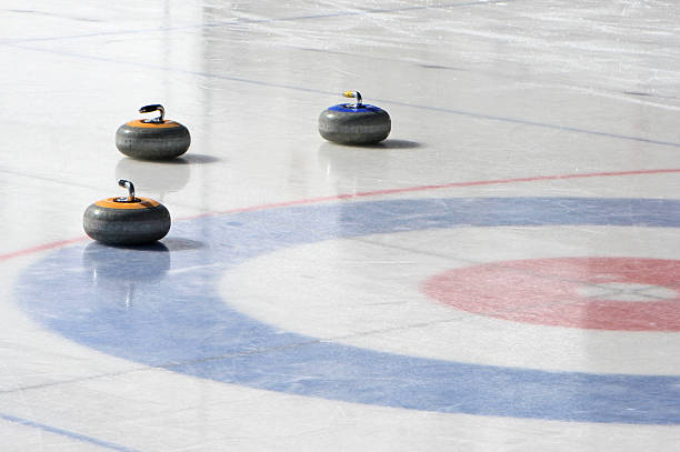 curling rocks on an outdoor rink - curling stockfoto's en -beelden
