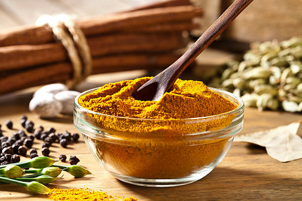 Curry Powder Curry Powder in a Bowl on Wooden Table curry powder stock pictures, royalty-free photos & images