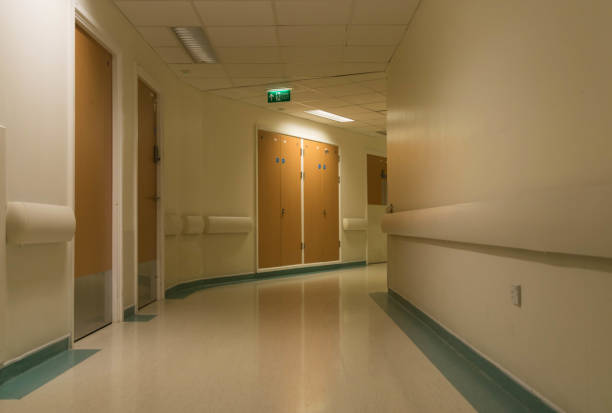 Curved hospital corridor at night stock photo