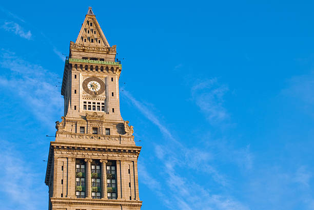 Custom House Tower in Boston, MA "The top of the Custom House Tower in Bostom, MA with blue sky surrounding it. Building was constructed in 1915.Other images of the Custom House and Faneuil Hall:" bell tower tower stock pictures, royalty-free photos & images