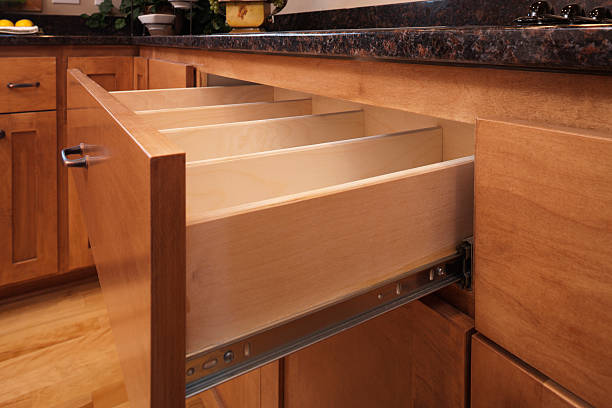 Custom kitchen cabinetry and utensil drawer. Custom kitchen cabinetry with a maple drawer pulled out for demonstration. customized stock pictures, royalty-free photos & images