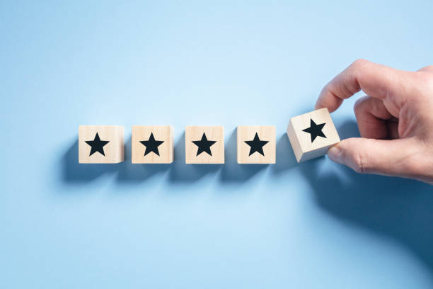 Customer experience feedback rate satisfaction experience 5 star rating wood blocks stock photo