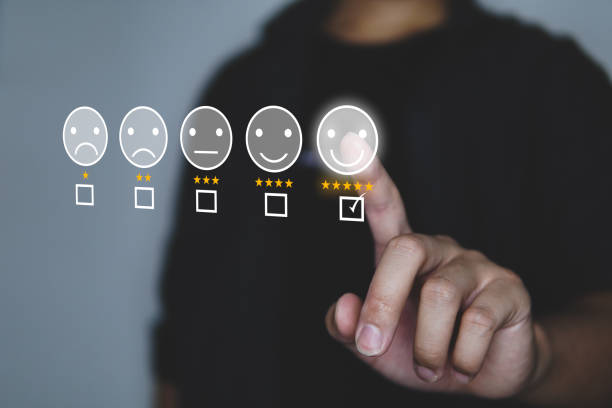 Customer review good rating concept people hand pressing smile face icon and five star on visual screen and positive customer feedback testimonial. stock photo
