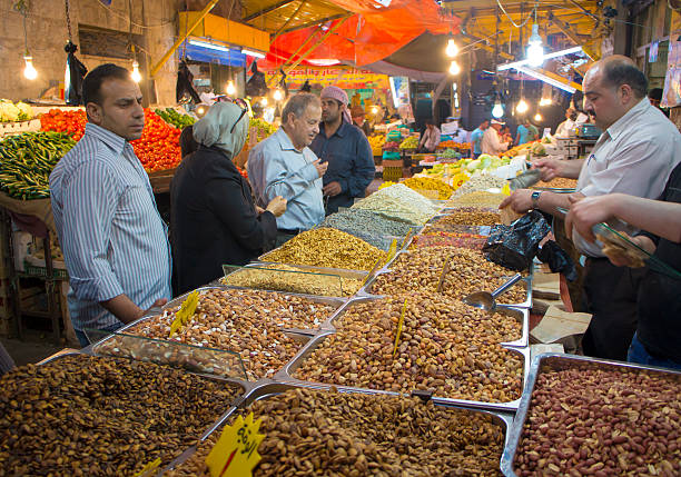 Customers buy nuts in a street market in Amman stock photo