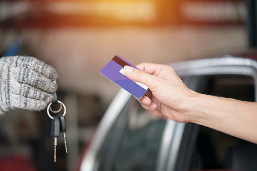 Customers Pay Car Repairs By Credit Card At Car Repair Center Stock