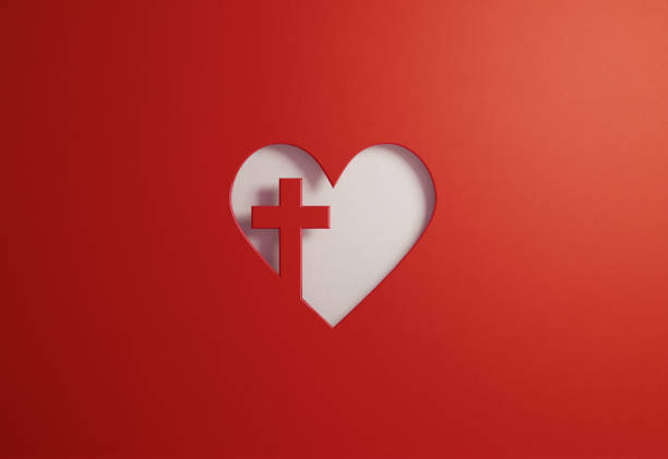 Cut out heart shape with a cross on red background. Great use for Good Friday and faith concepts. Horizontal composition with copy space.