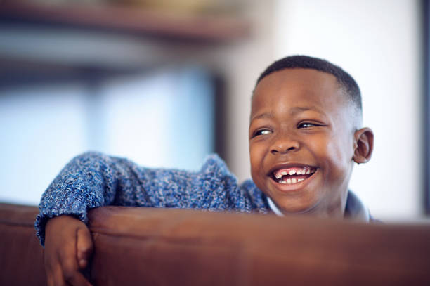 Cute African Boy with a big smile looking away stock photo