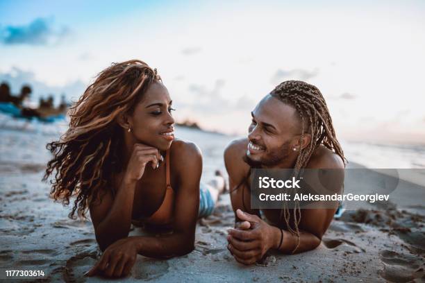Cute African Couple Lying Down At The Beach