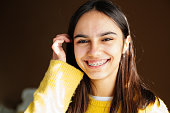 istock Cute and happy teen girl with braces smiling to camera 1299140003