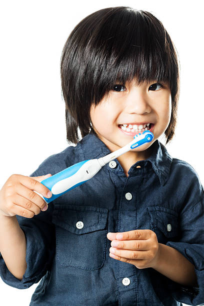 cute asian boy brushing teeth. - asiatic kids room imagens e fotografias de stock