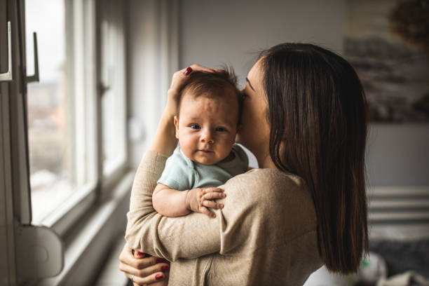 Cute baby girl and her mother stock photo