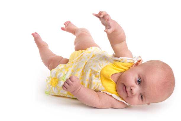 Cute baby rolling over isolated on white background stock photo