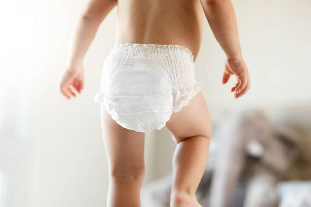 Cute baby using diapers stock photo