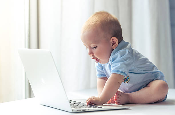 Cute baby with laptop stock photo