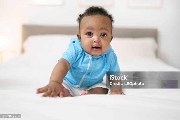 Cute black afro american Baby On Parent Bed