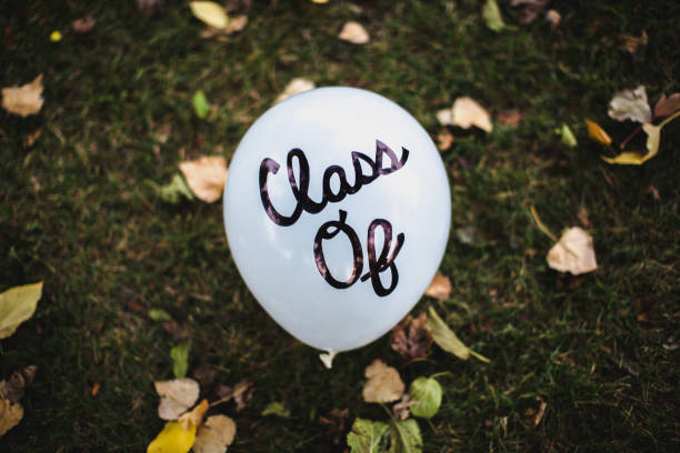 Cute Centered DIY Script Cursive Handwriting "Class of" on White Balloon Celebrating Graduation Cute DIY Script Cursive Handwriting "Class of" on White Balloon Celebrating Graduation colorado plateau stock pictures, royalty-free photos & images