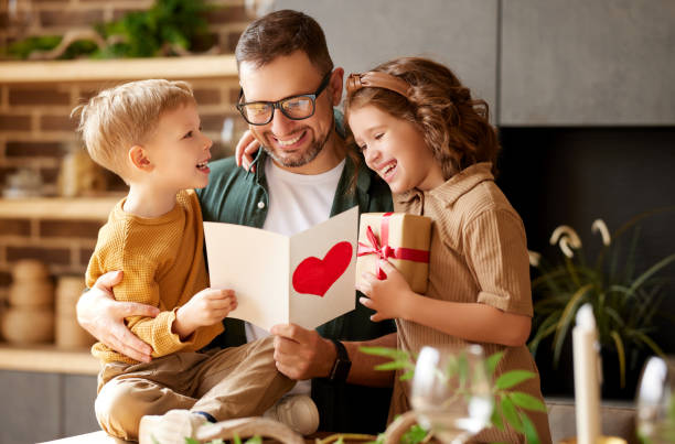Cute children congratulating happy daddy with Fathers day and gi stock photo