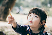 istock Cute Chinese girls having breakfast and picnic in the park 1294082516