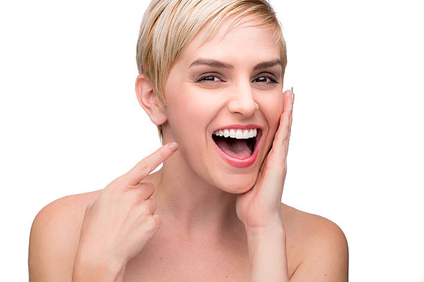 Cute fun laughing perfect white teeth straight smile pointing mouth stock photo