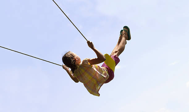Cute Girl Swinging High stock photo