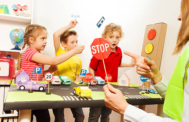 cute kids having fun teaching traffic signs - trafiklärare bildbanksfoton och bilder