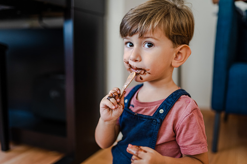 Cute little boy enjoy eating ice cream at home