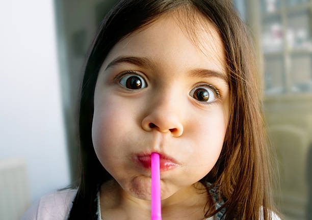 Cute little girl making faces stock photo