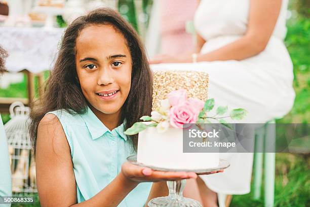 Cute little girl with pretty cake at a party