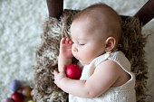 istock Cute little toddler baby boy, sleeping with colorful easter eggs and little decorative ducks 1369340501