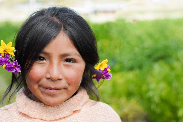 Cute native american kid outside. Beautiful native american little girl with flowers in her hair. peru girl stock pictures, royalty-free photos & images
