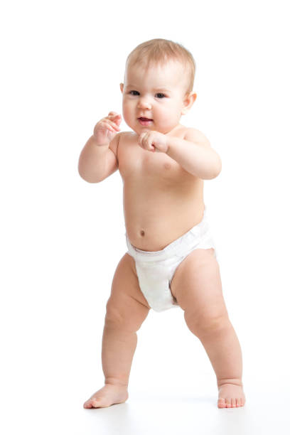 Cute smiling baby learning to walk. Kid weared diaper Isolated stock photo