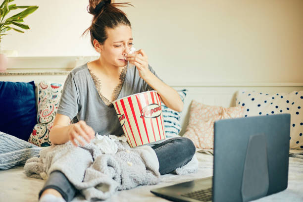 Cute woman watching movie at home. stock photo