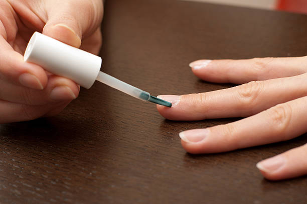 Cuticle care, brushing cuticle remover around nail