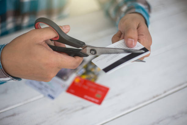 Cuting credit cards with scissors. stock photo