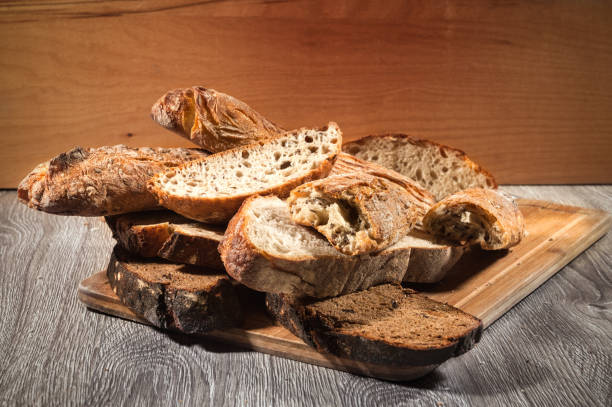 cuttind bread on dark stock photo